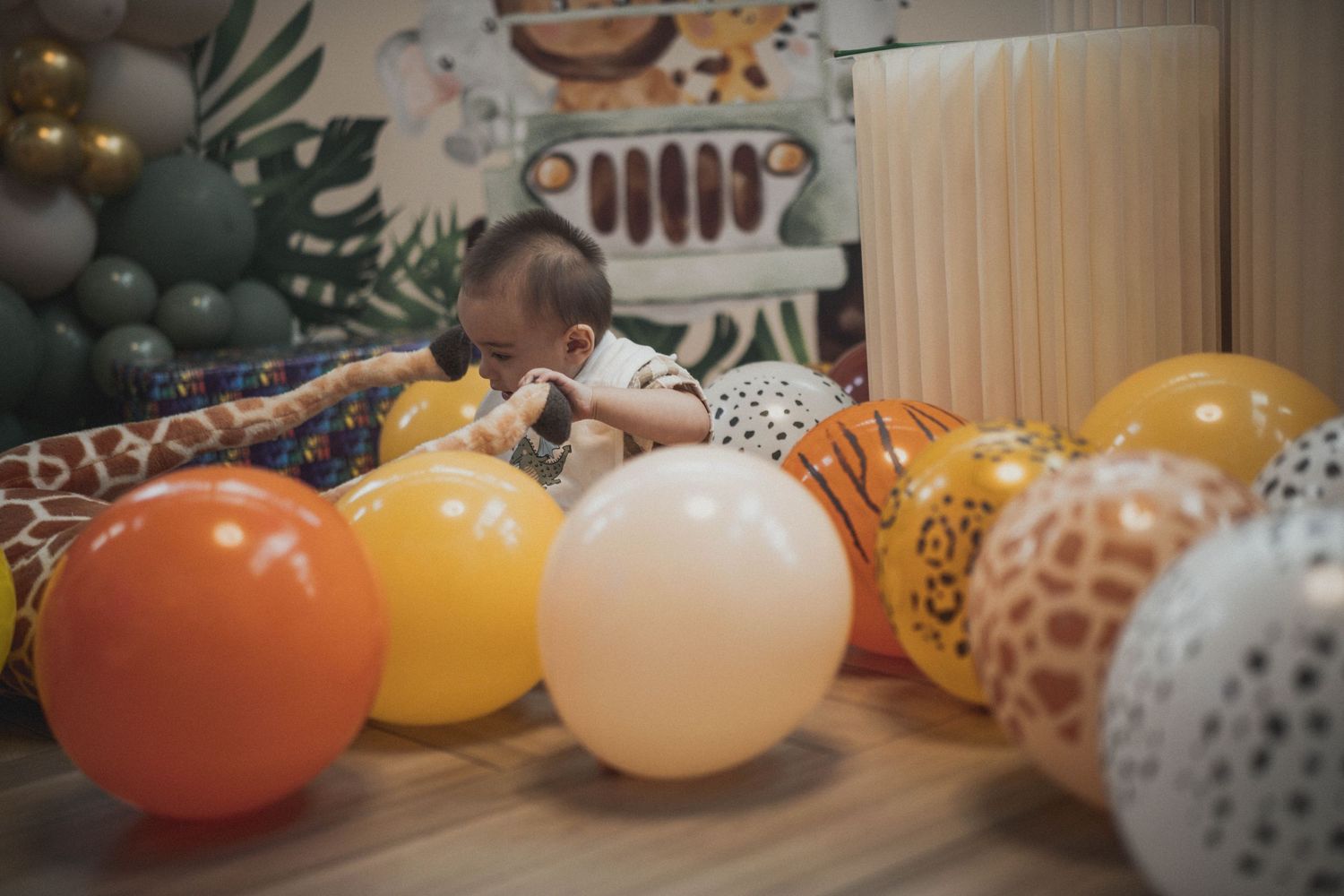 Colorful balloons scattered on floor near party decorations.