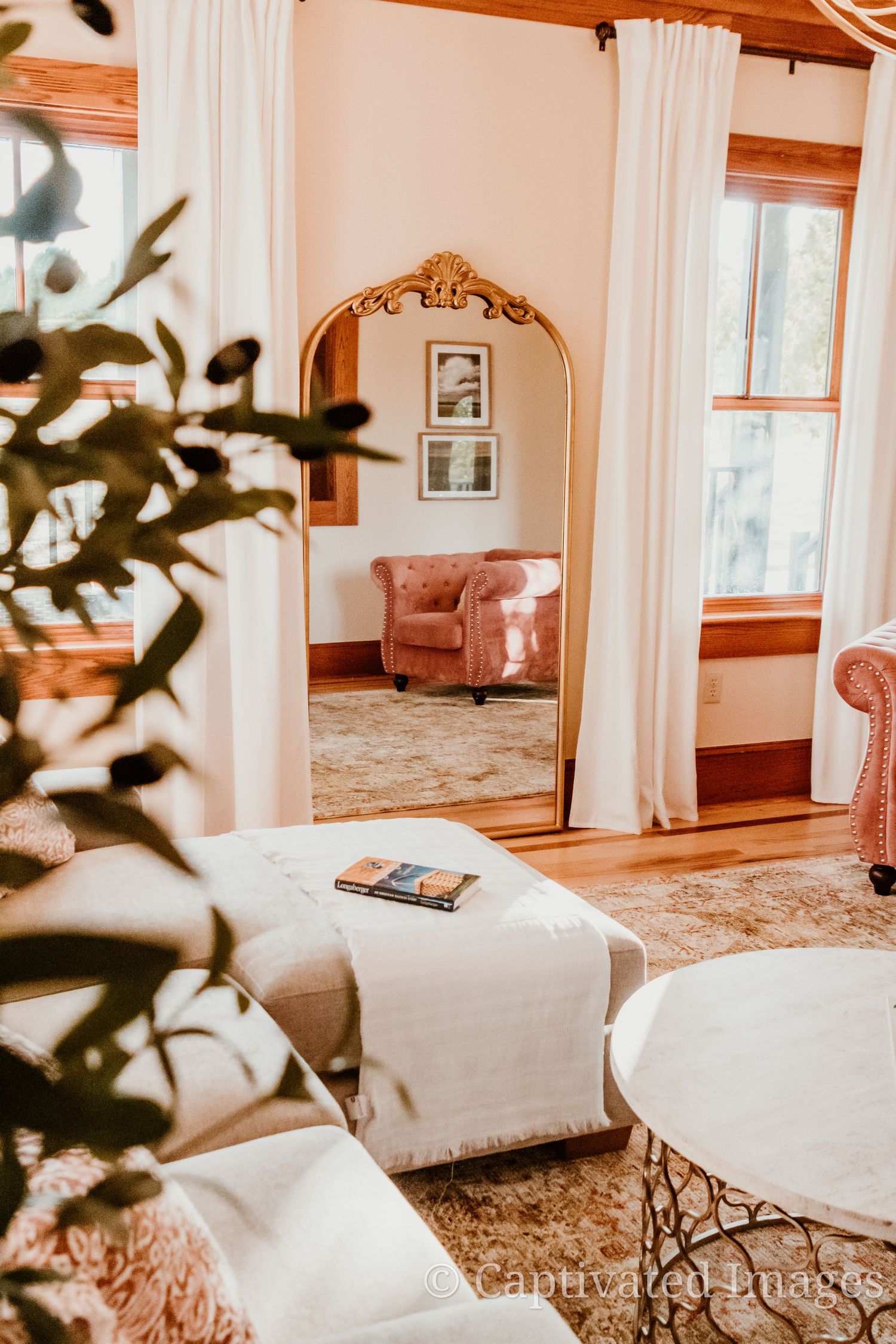 Bright and airy bedroom interior with white curtains, natural light, and wooden accents creating a cozy atmosphere.