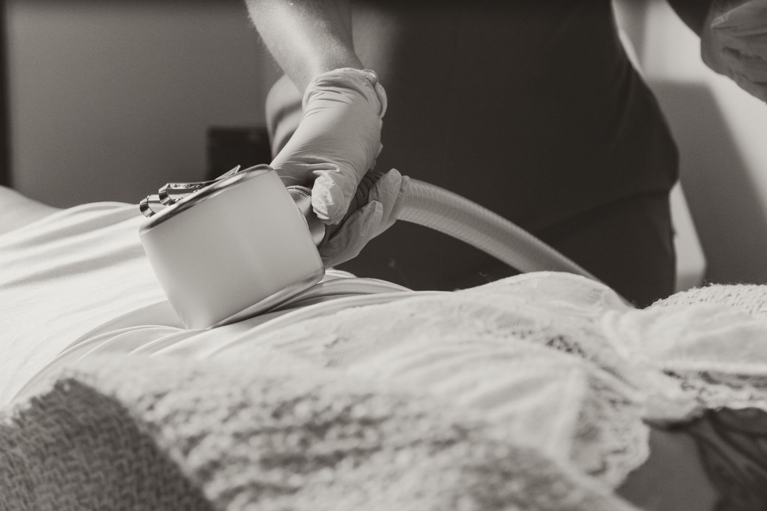 Close-up view of hands performing a beauty treatment using professional equipment.