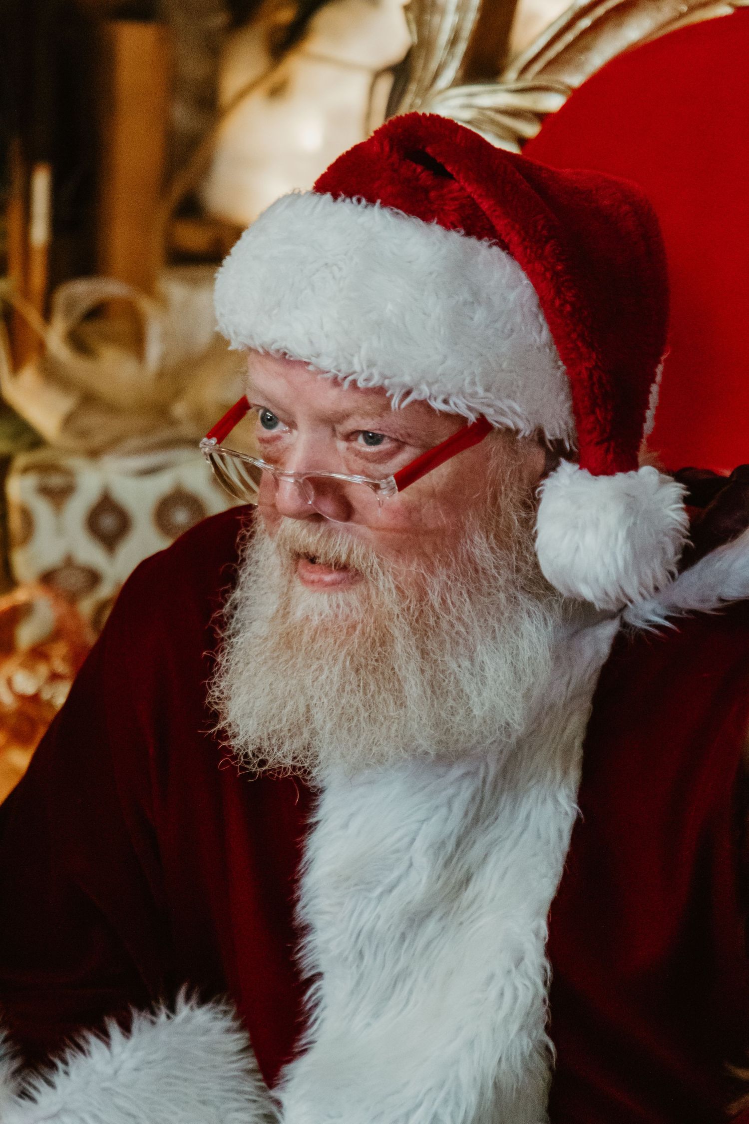 Classic holiday portrait of figure in traditional red and white festive attire with white beard.