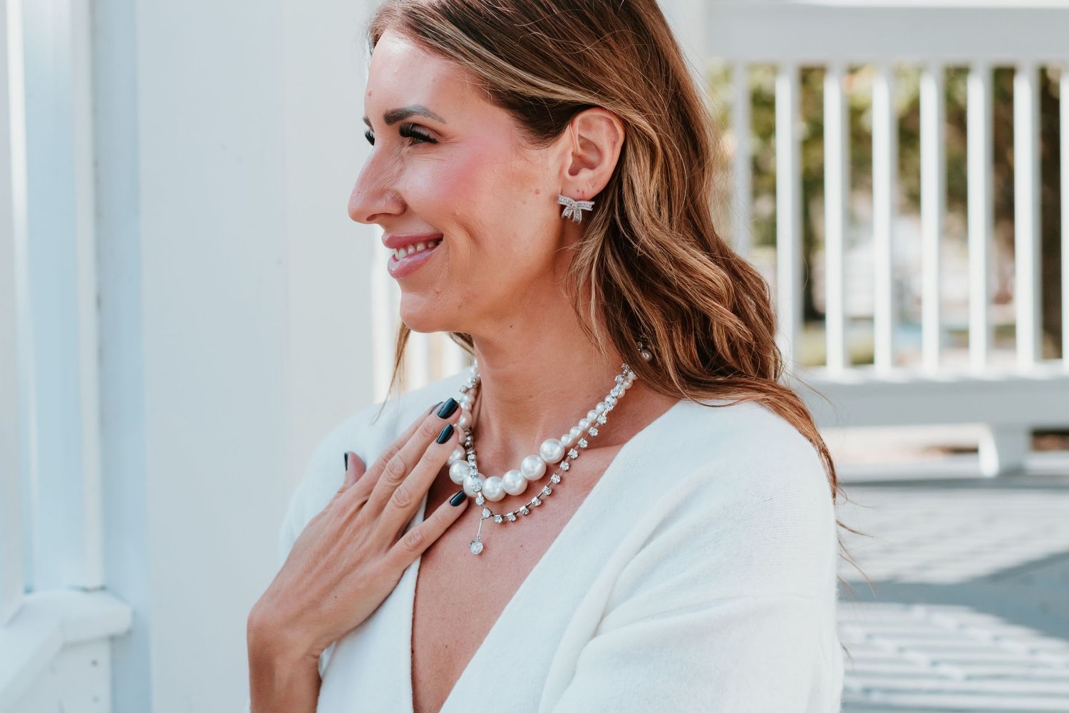 Elegant bridal portrait showcasing statement necklace and delicate jewelry.