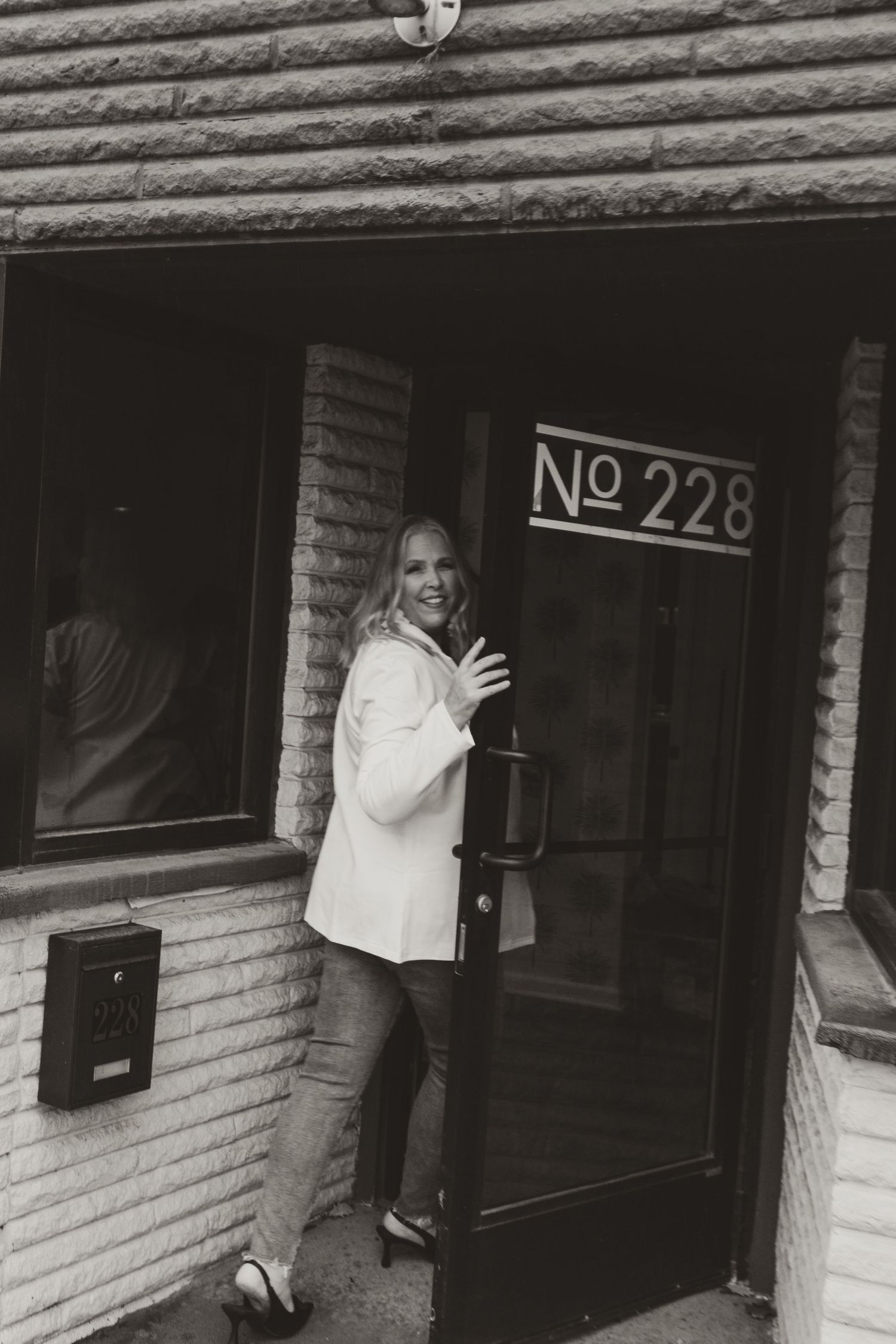 Black and white photo of entrance to building number 228.