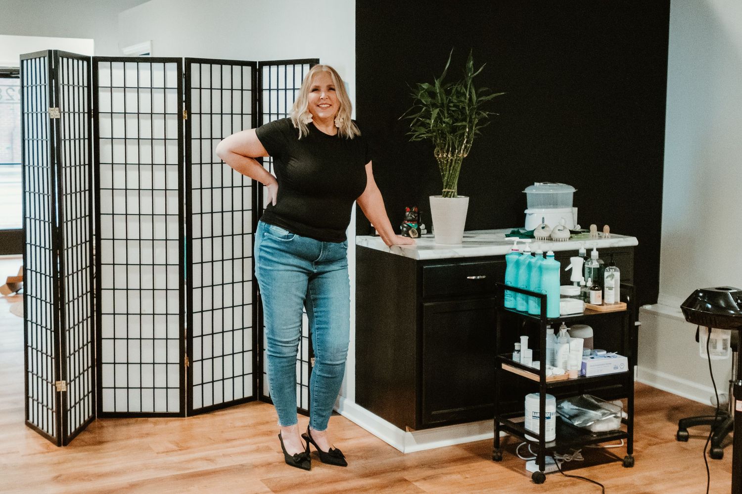 Modern salon interior with folding screen divider and styling station.