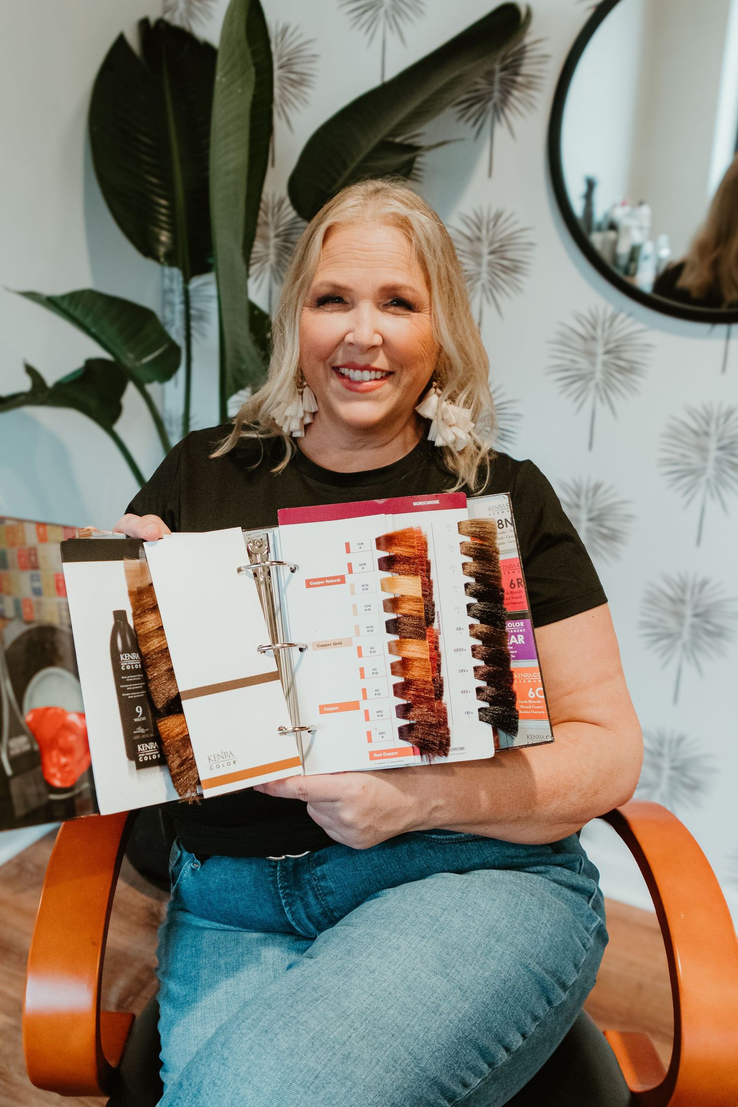 Color chart display featuring various hair dye shades in organized binder.