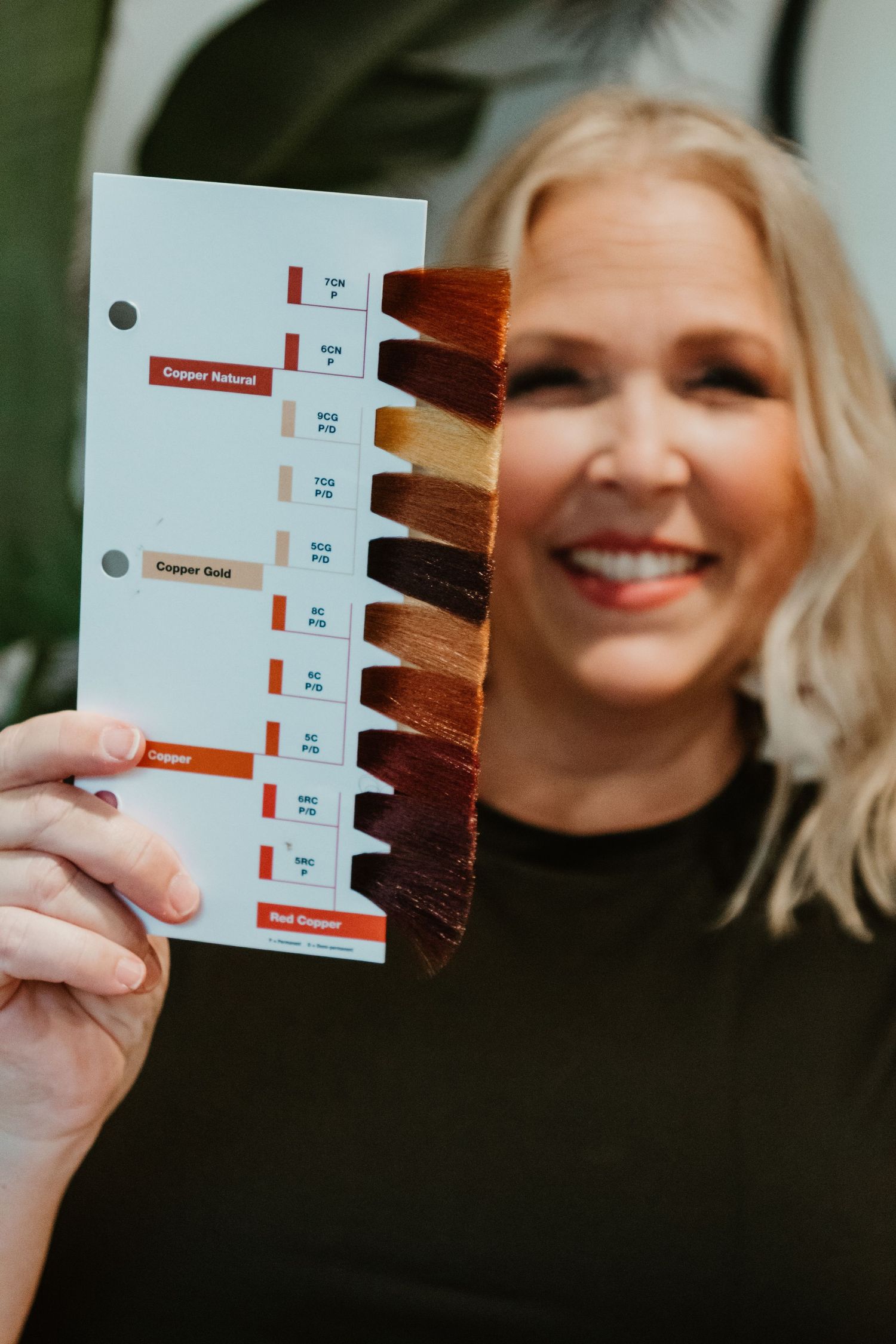 Hair color swatch chart displaying various shades of red and brown.