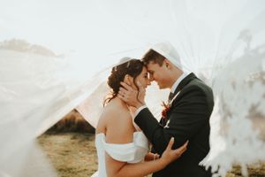 Romantic wedding portrait with couple embracing as smoke surrounds them in golden light. Wedding photographer Johnstown Somerset PA
