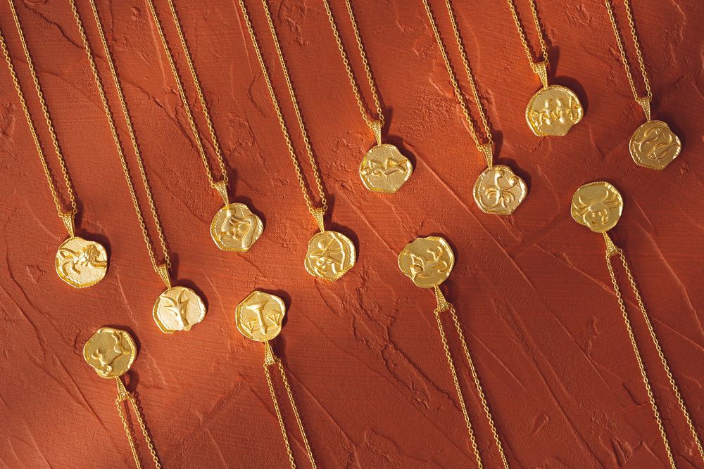 Glowing golden Christmas lights hanging against a rustic red wooden background create a warm holiday ambiance.