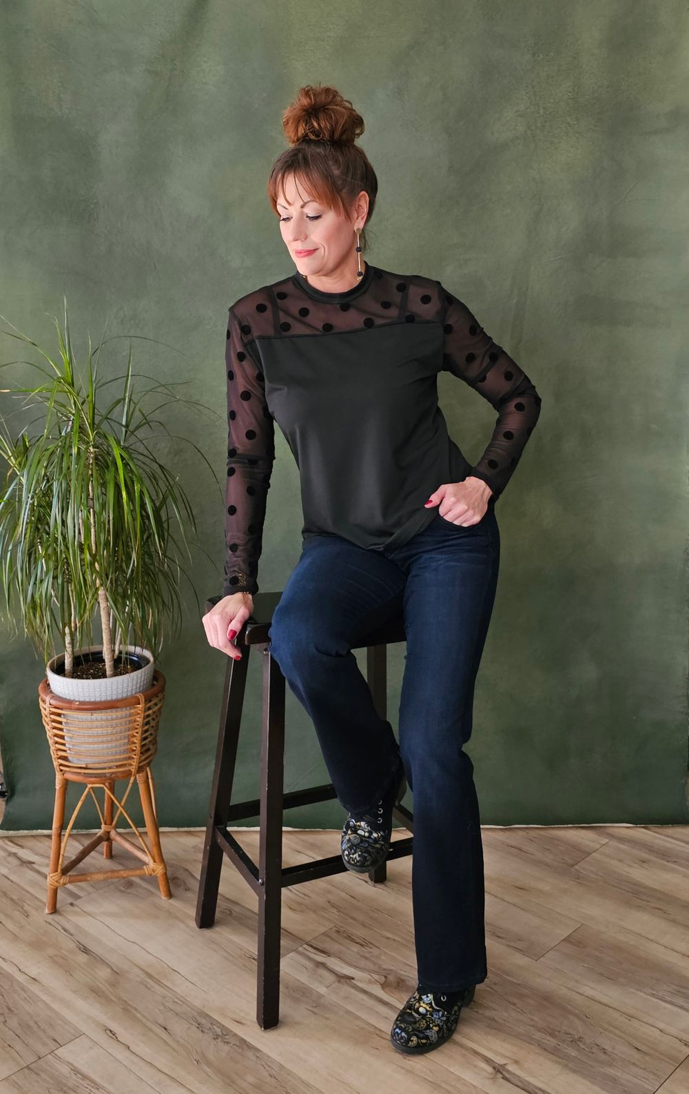 A series of photos showing someone in a black polka dot top and jeans posing next to a potted plant on a wooden floor.