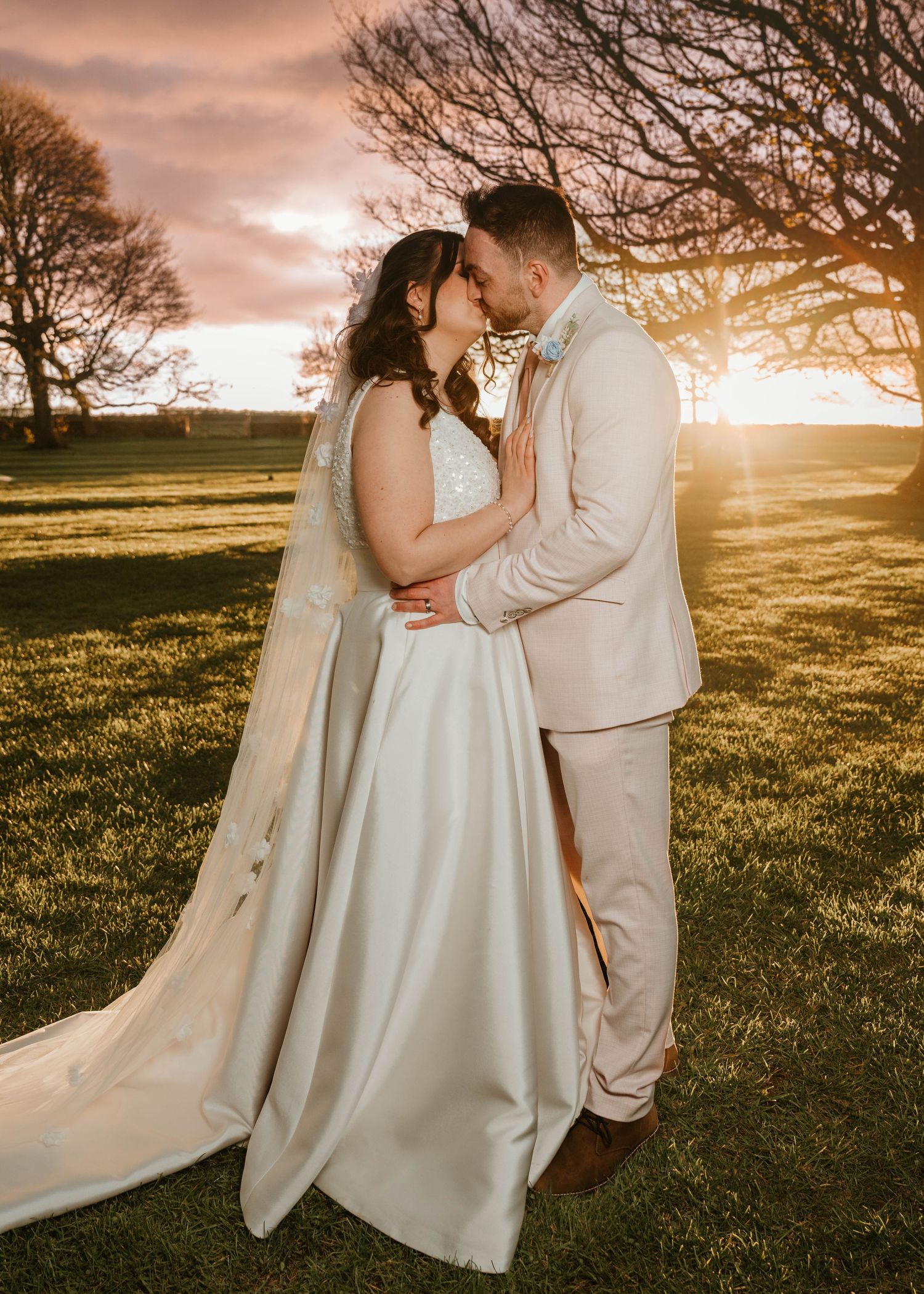 Ethereal bridal portraits in moody lighting showing flowing white wedding dress and delicate veil details.