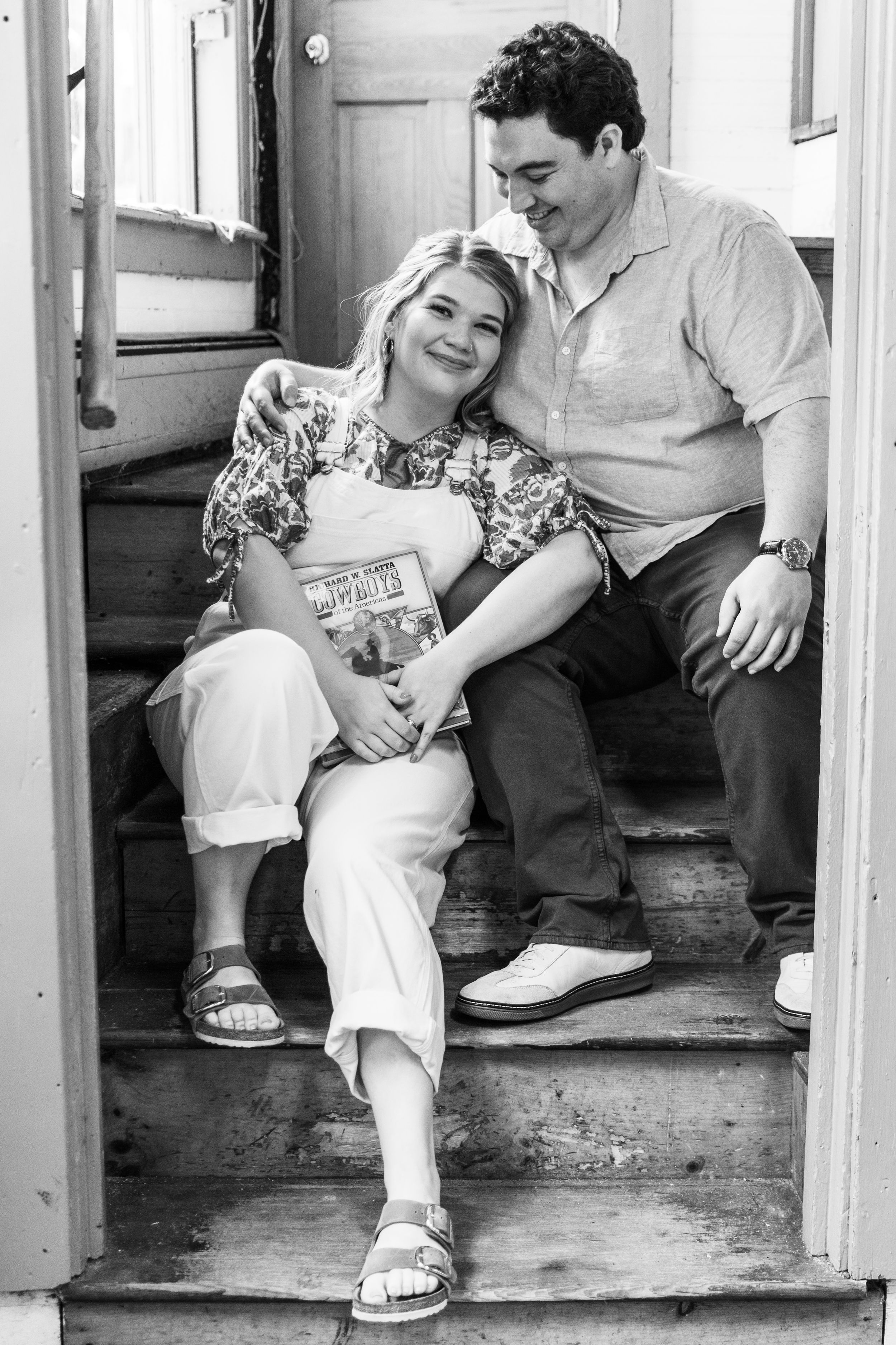 A casual moment shared on wooden steps with people sitting and laughing together.