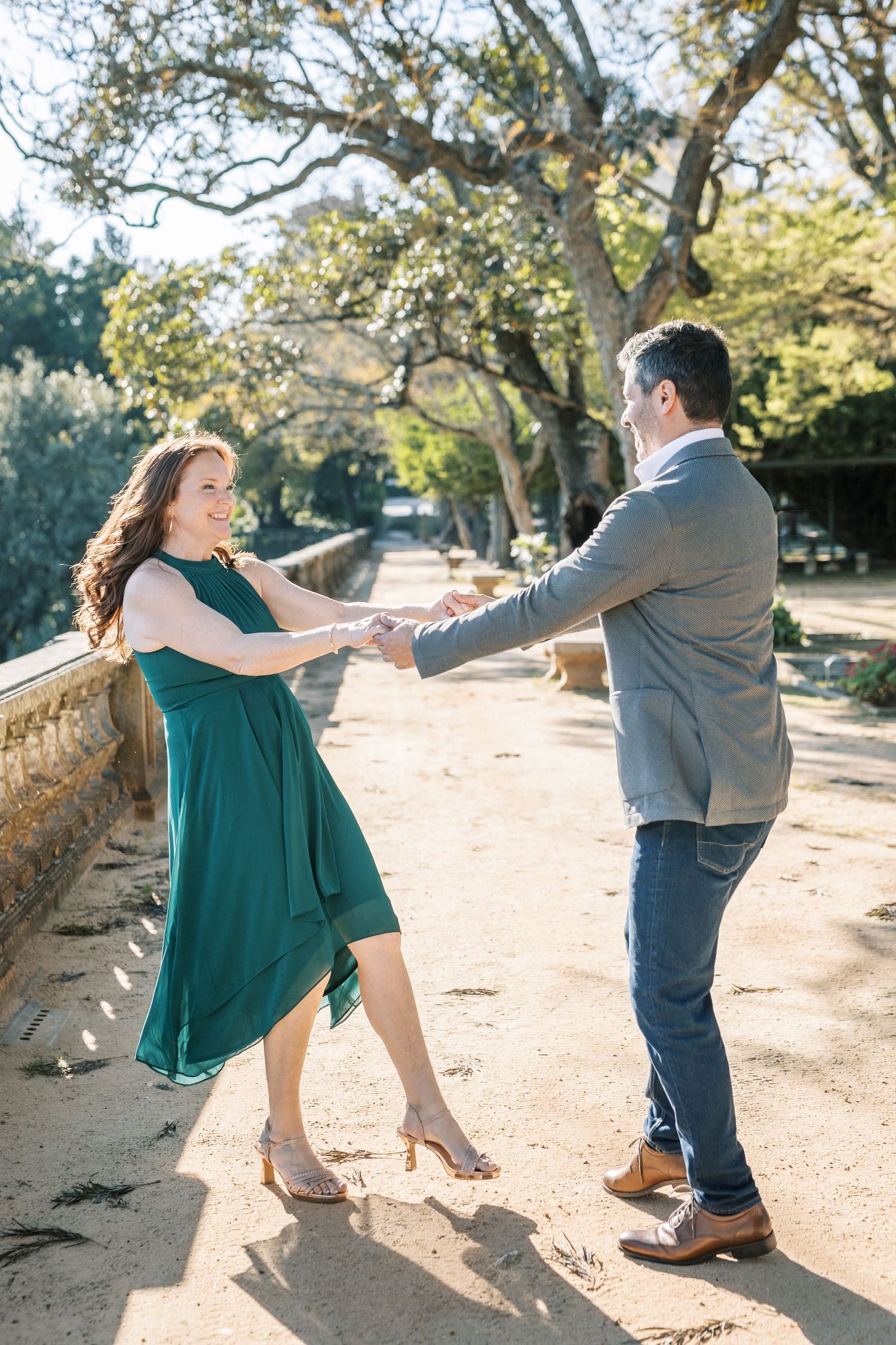 Couple laughing during engagement session in Lisbon garden