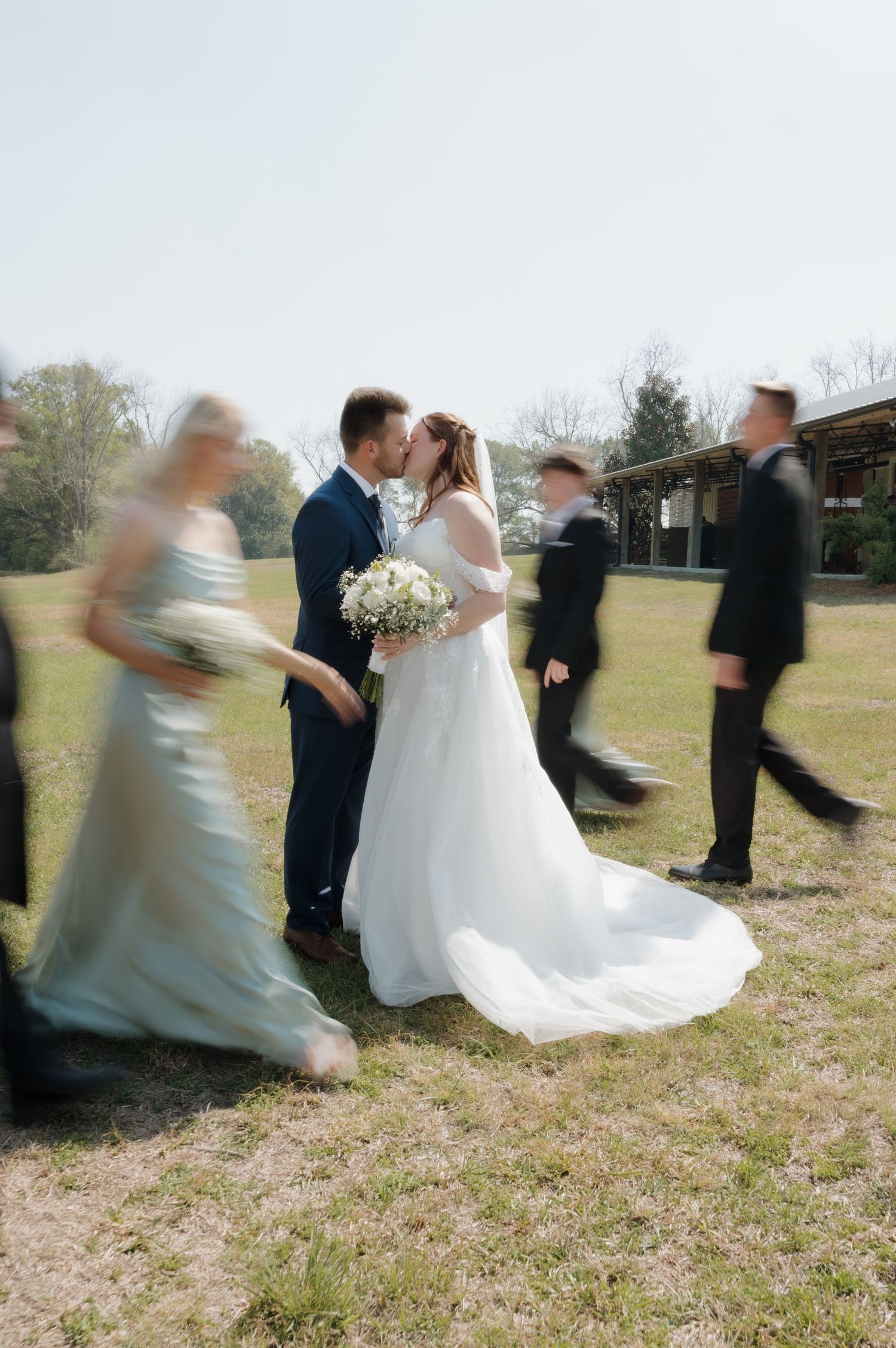 Motion blur sequence of a wedding party walking and spinning outdoors.