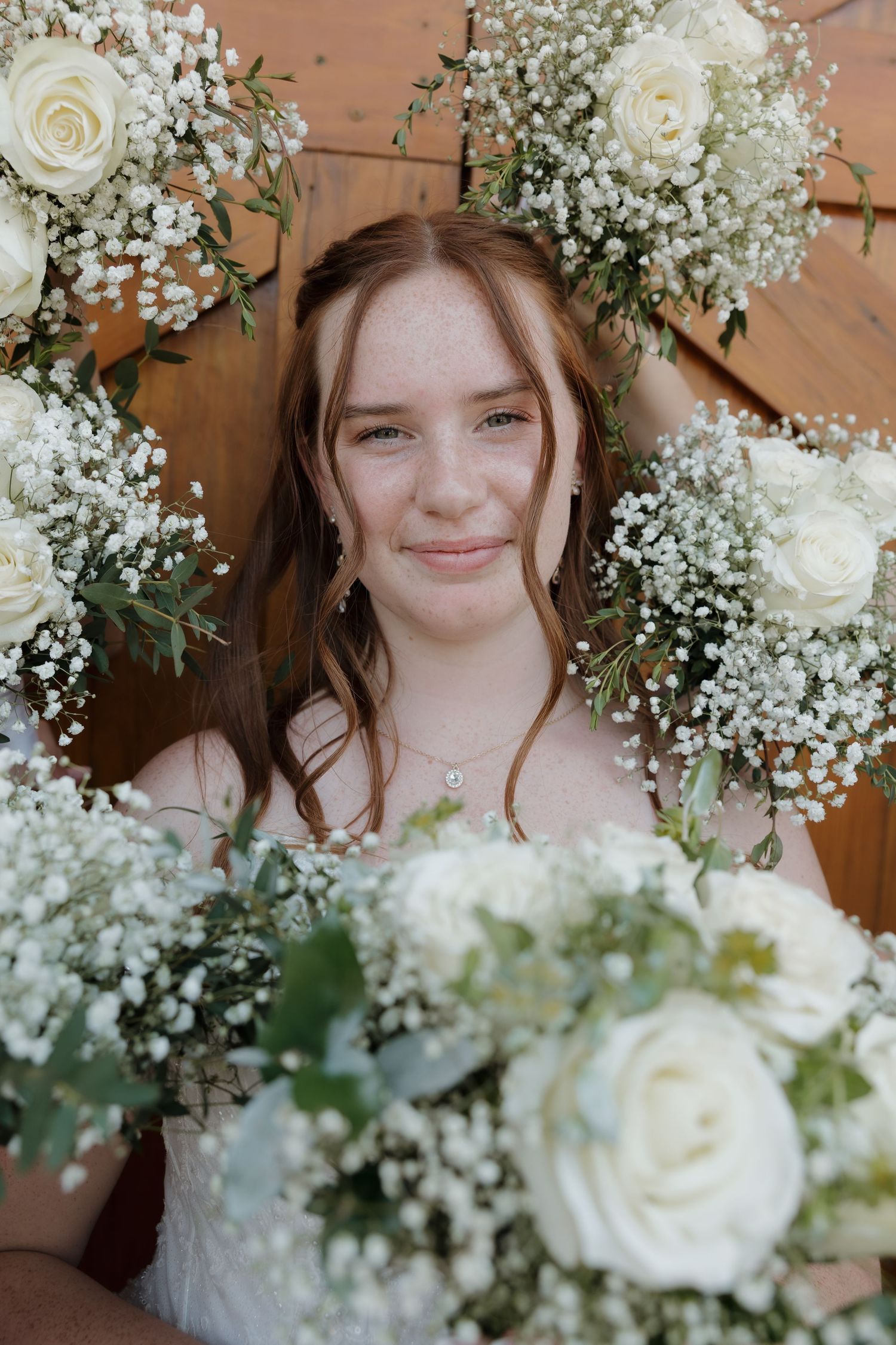 White roses and baby's breath floral arrangements create a romantic bridal aesthetic.