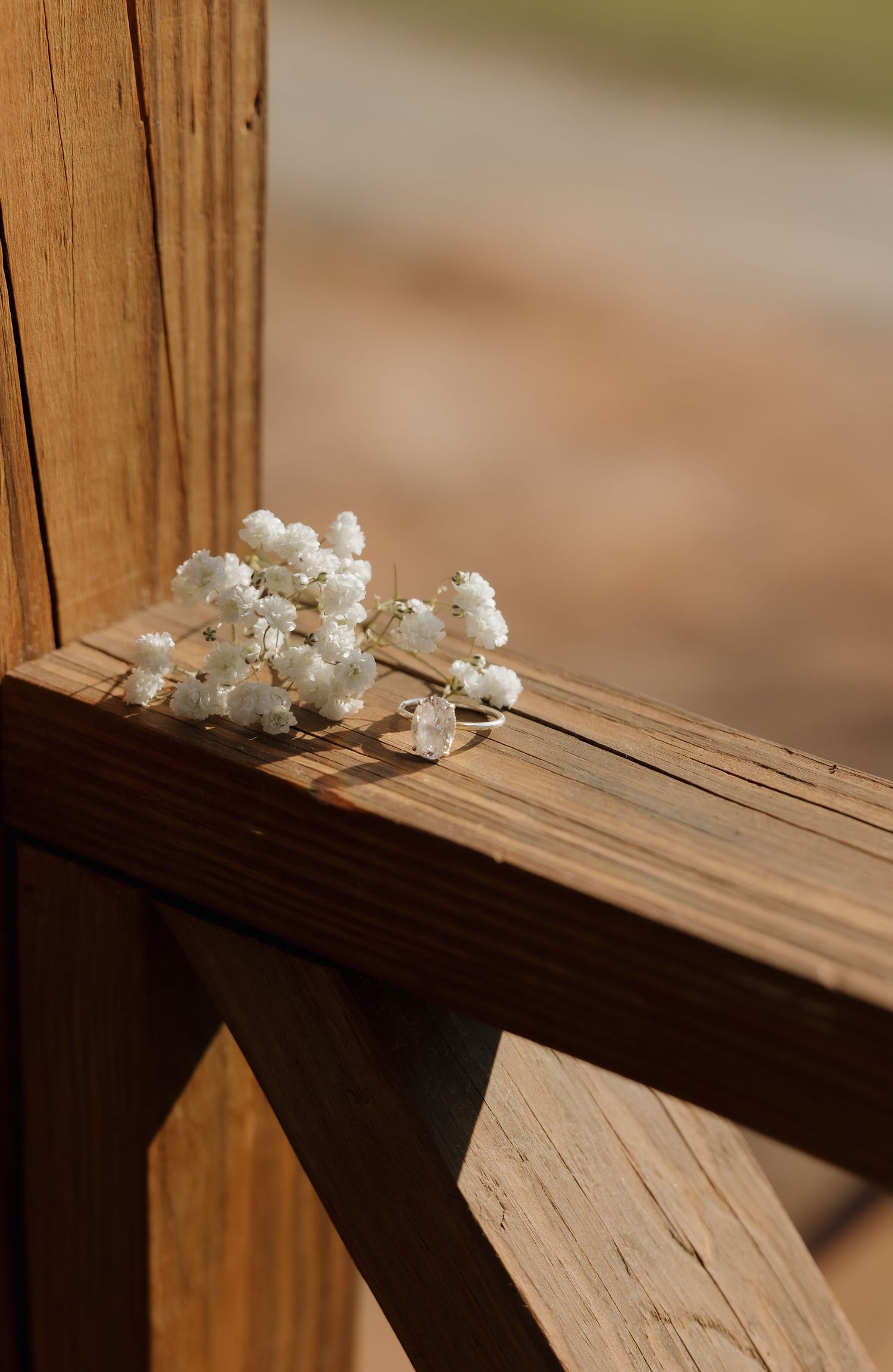 White flowers arranged delicately on a rustic wooden ledge in a minimalist style.