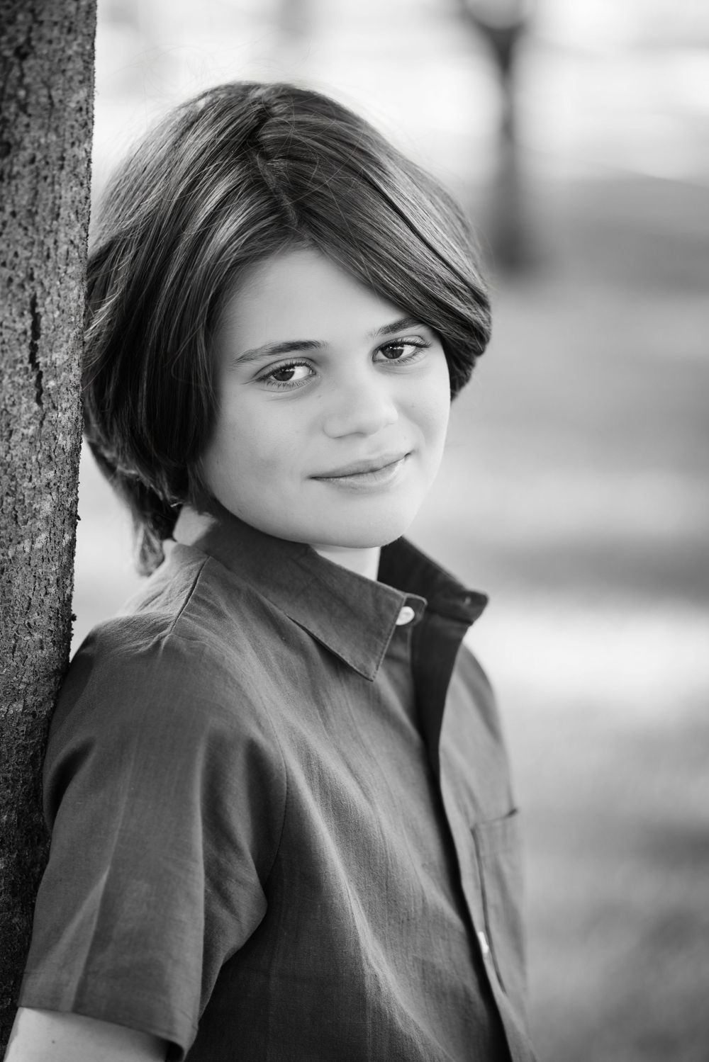 Black and white portrait series showing expressions in a casual outdoor setting.