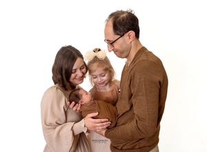 A loving family in warm brown tones shares tender moments together in a series of connected photos.
