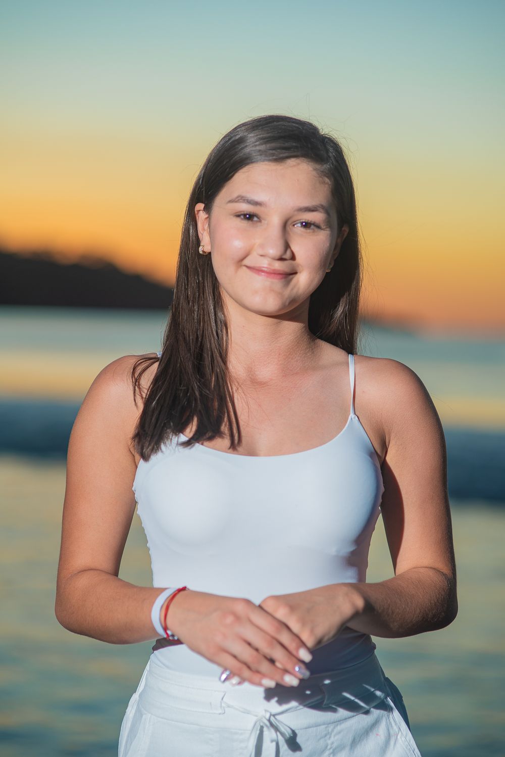 A series of sunset beach portraits showing a young person in a white top against the ocean backdrop at golden hour.