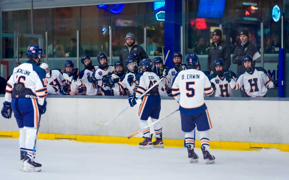 Hershey Trojans players at the bench after a goal at IceWorks during the Flyers Cup Quarterfinals by SportsFox Photography, Hershey PA.