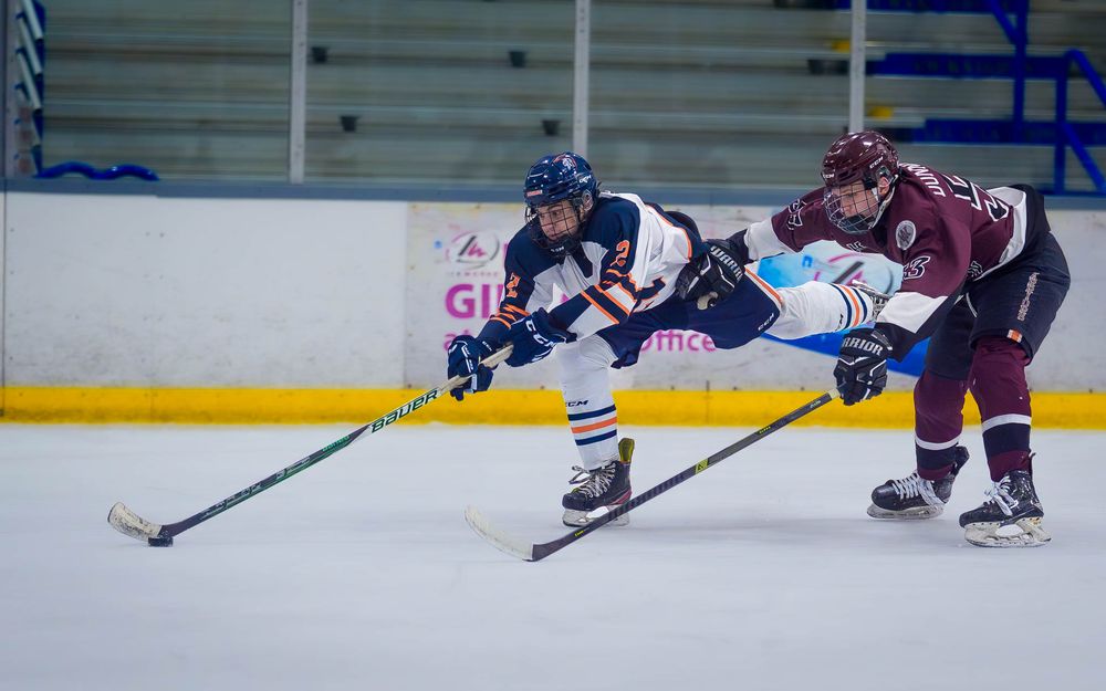 Hershey High School hockey player battling for the puck at Flyers Cup quarterfinals vs West Chester by SportsFox Photography, Hershey, PA