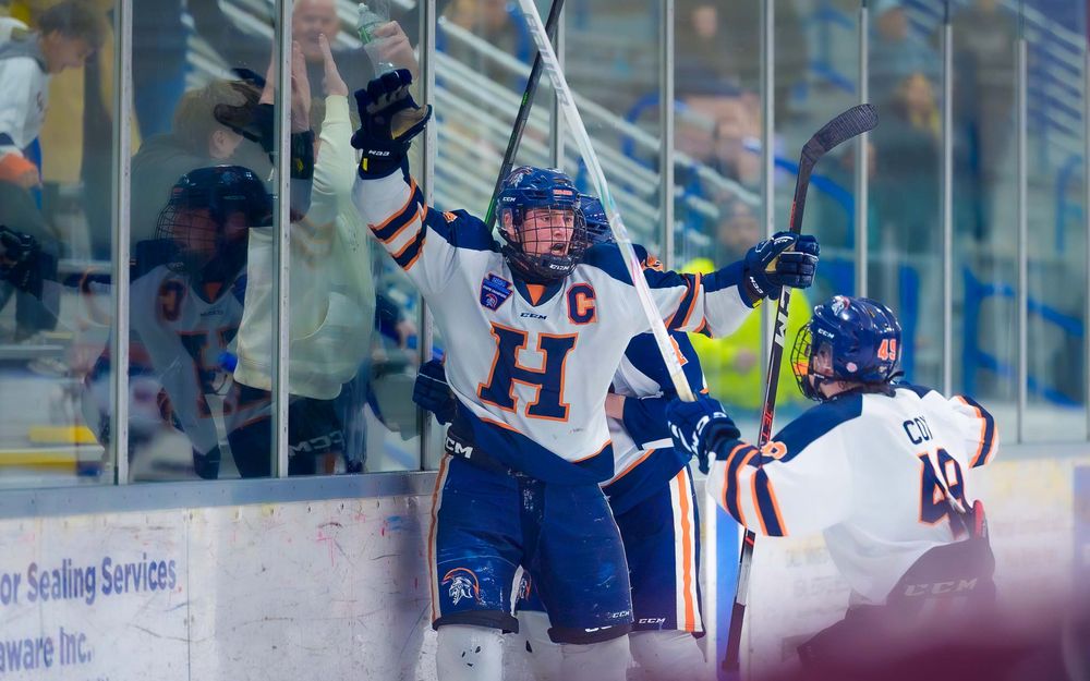 Hershey Trojans player celebrates at the boards at IceWorks in the Flyers Cup Quarterfinals by SportsFox Photography, Hershey PA.