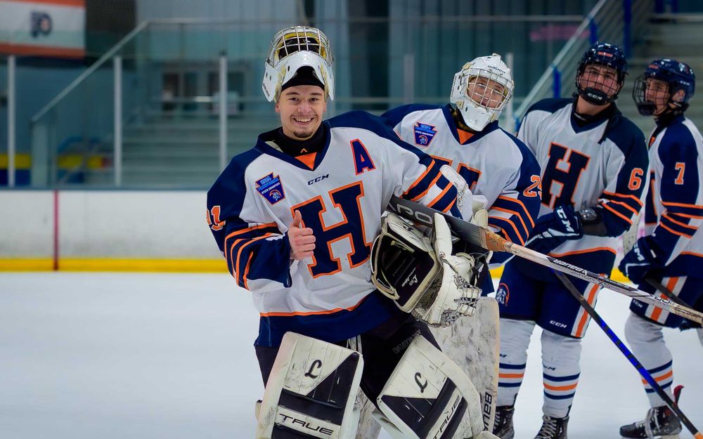 Hershey Trojans goalie skates with teammates after winning the Flyers Cup Quarterfinals at IceWorks  by SportsFox Photography, Hershey PA