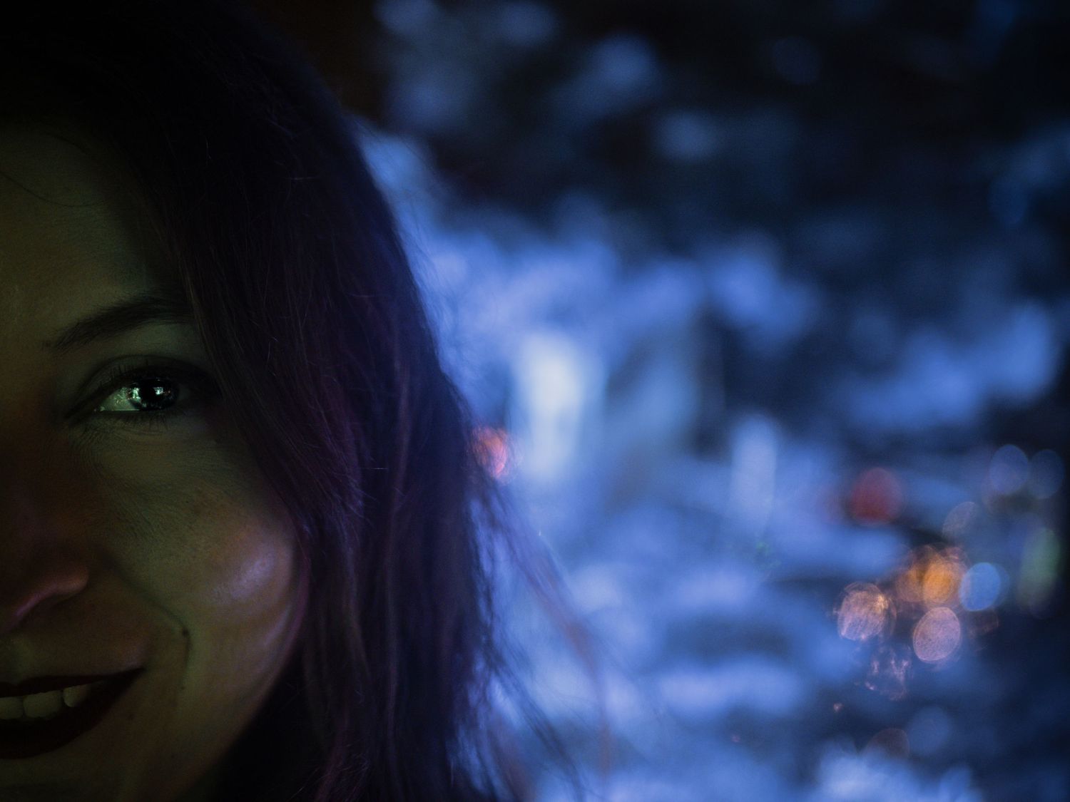 Abstract blue bokeh lights create dreamy atmospheric background effect.