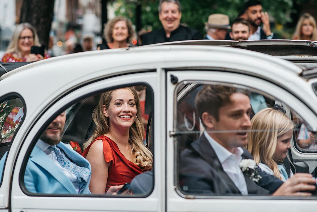 wedding photography london. bride and groom in the back of a car