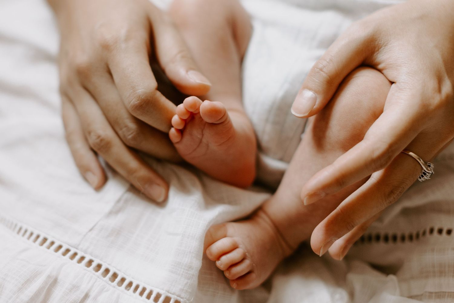 A cozy home photography session for a family with a newborn baby and dogs.