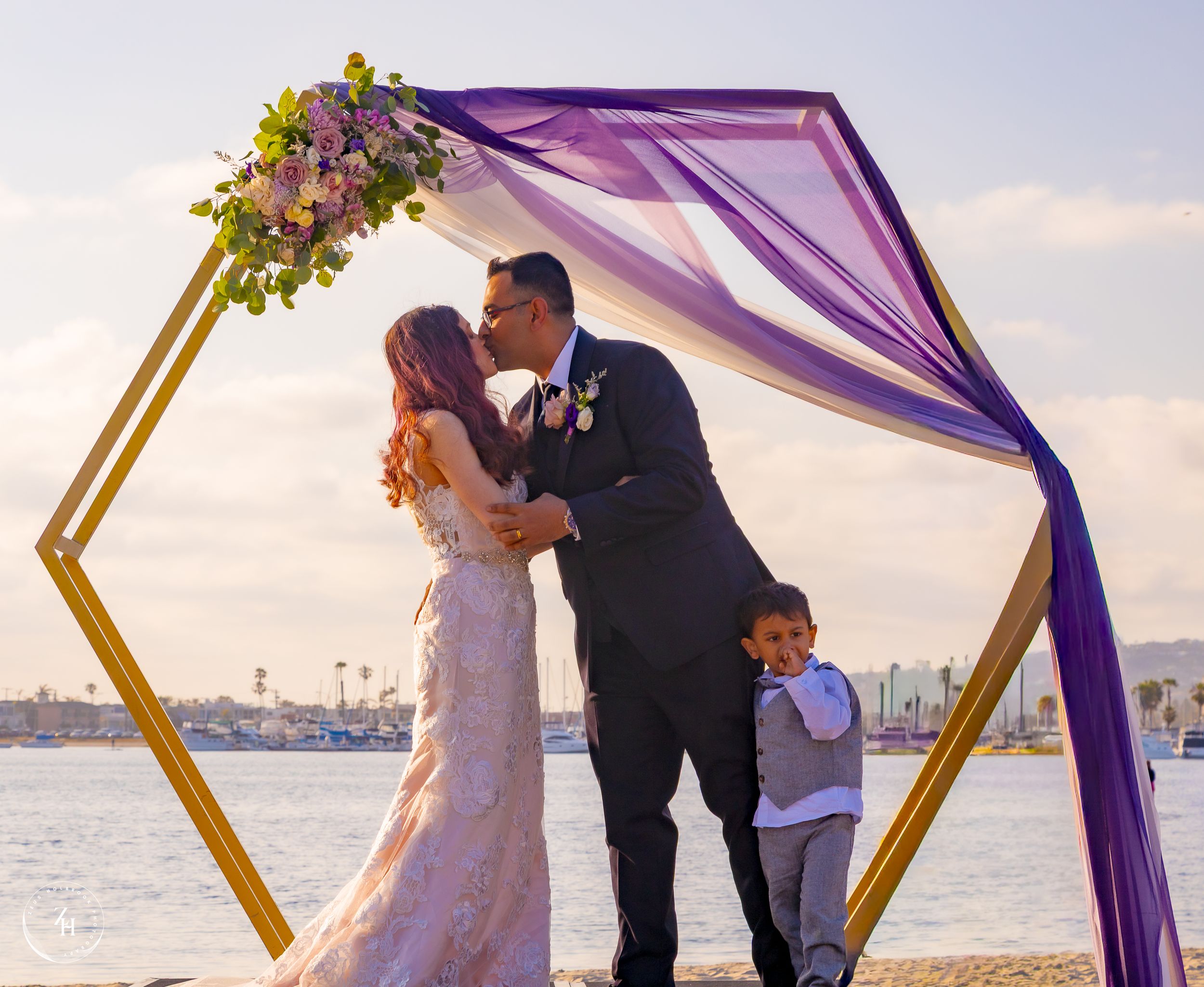 Zeus Holbrook San Diego Wedding Photographer Captures First kiss at vow renewal in mission beach