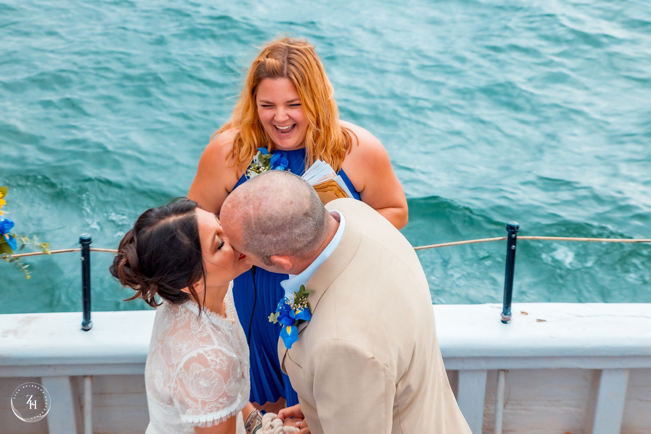 Wedding kiss on the Bill of Rights ship with ocean views photographed by Zeus Holbrook San Diego Wedding Photographer