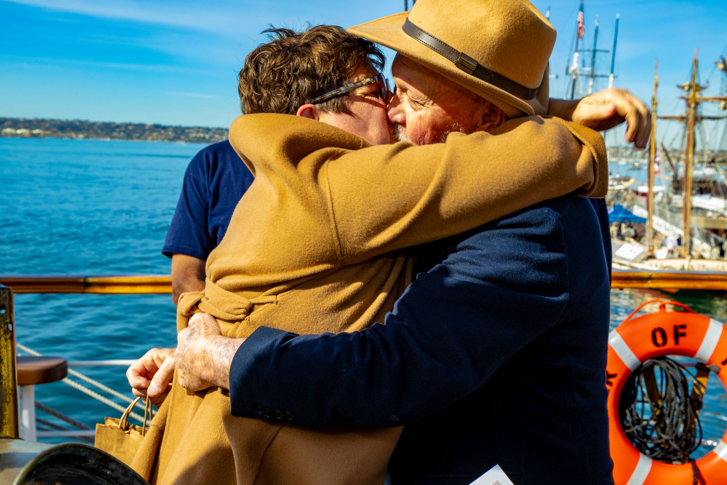 Couple embracing on a historic ship in San Diego harbor captured by Zeus Holbrook San Diego Wedding Photographer