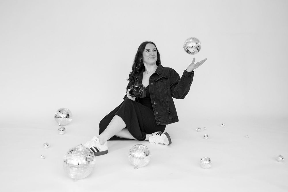 A series of black and white photographs showing a person in dark clothing interacting with a white balloon on a light background.