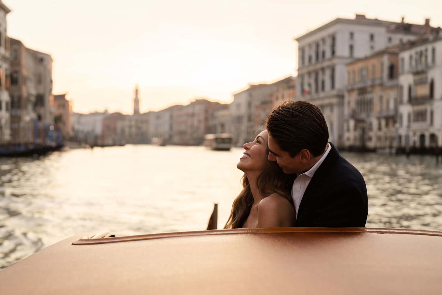 Romantic couple shares intimate moments across six connected photos along Venice's scenic Grand Canal at sunset.