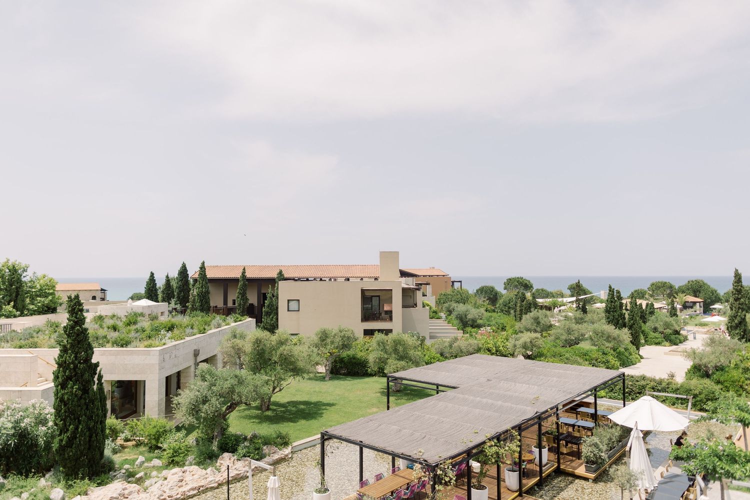Scenic desert resort property with adobe-style buildings nestled among green landscaping and mountain views.