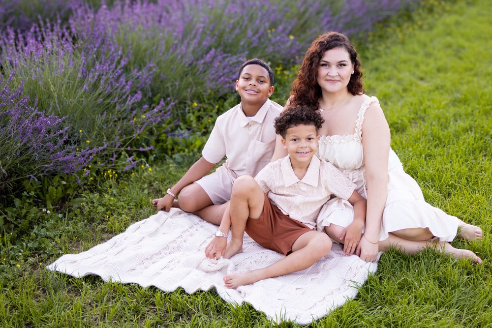 family sitting on blanket in grass