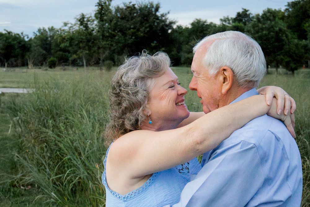 couple hugging in field