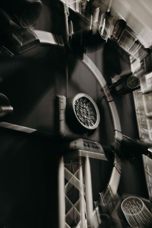 Industrial ceiling mounted equipment and ventilation systems in dark performance space.