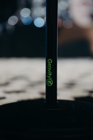 Close-up of professional audio equipment with green LED display indicators in dark setting.