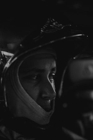 Dark moody profile shot of someone wearing protective headgear.