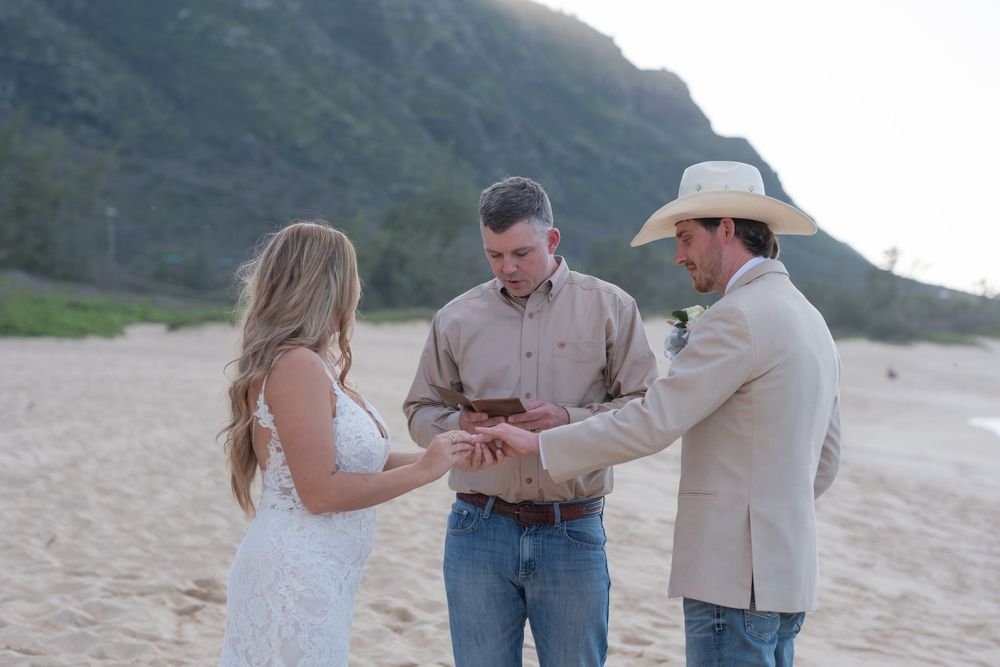 Bride and groom signing their marriage license during an intimate beach wedding ceremony on Oahu.