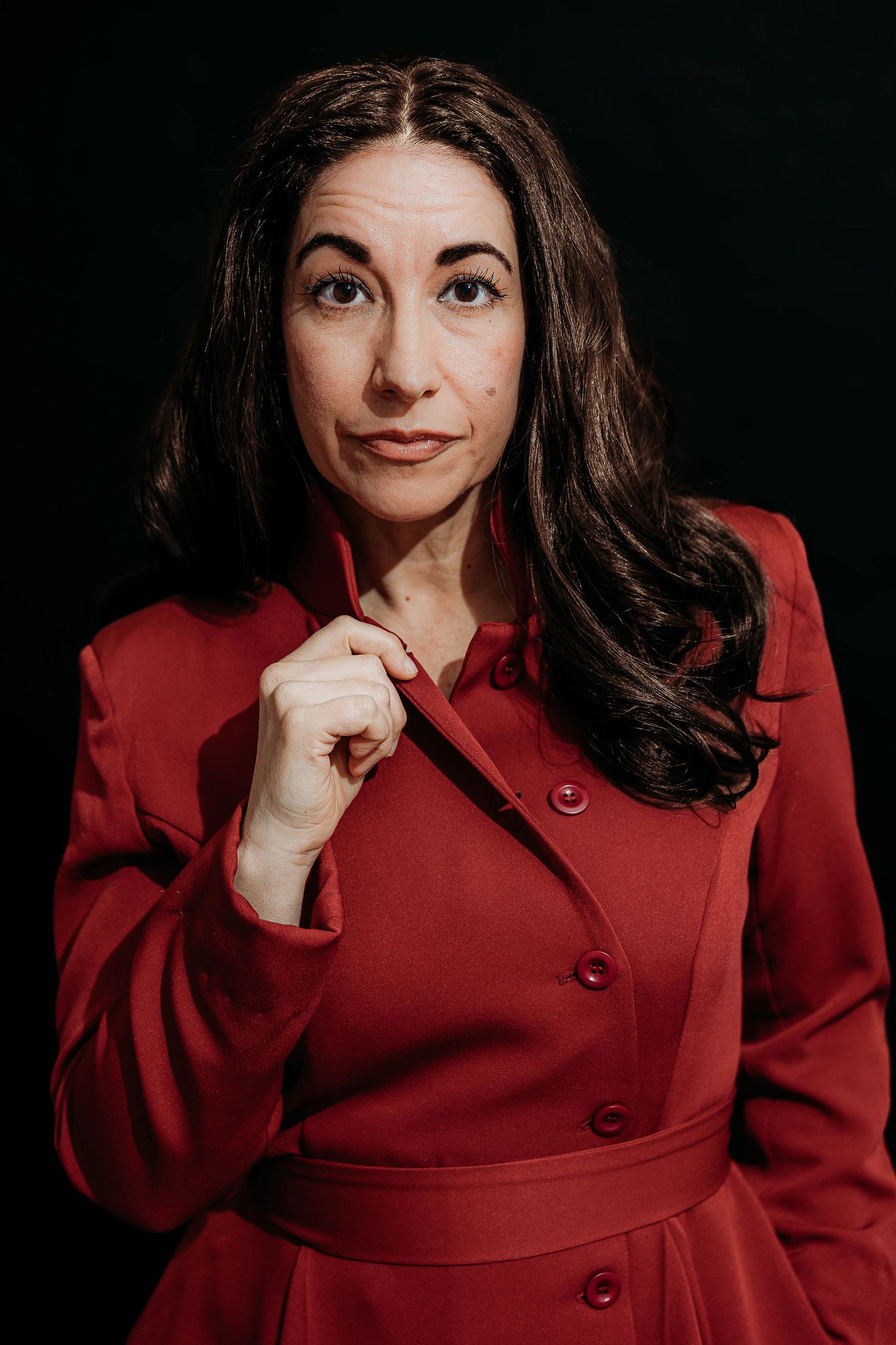 Portrait series showing expressive poses in a red blazer against dark background.