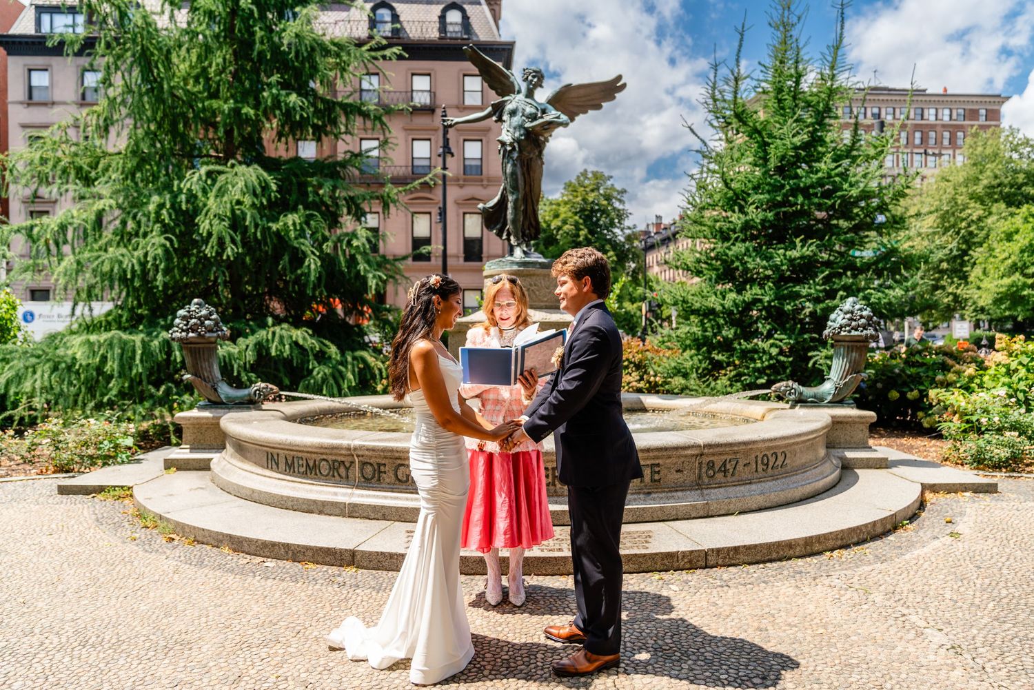 Couple getting married at Boston Public Garden during an outdoor wedding ceremony in Boston, MA.