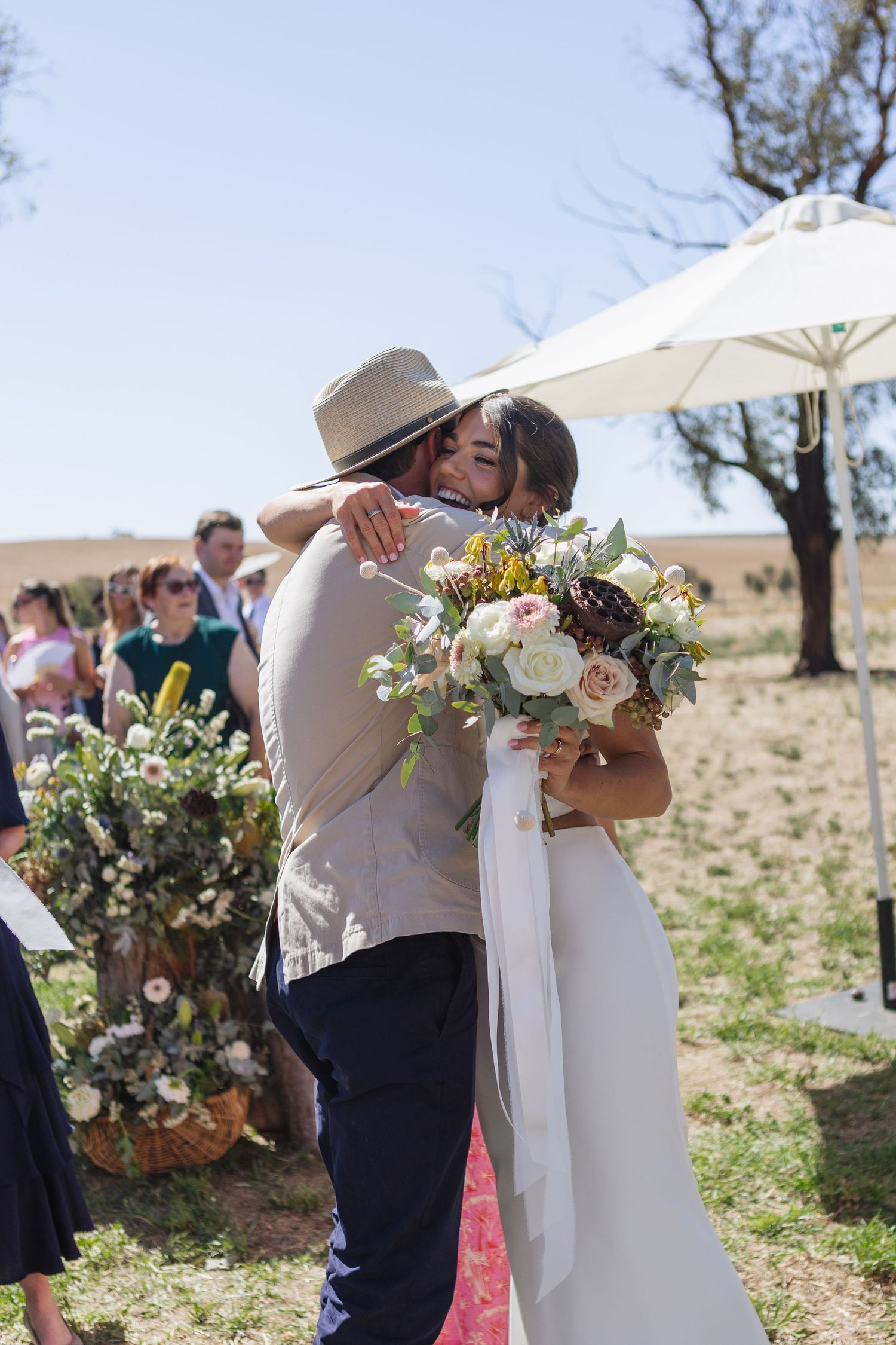 Bride and brother hugging after ceremony at country NSW wedding