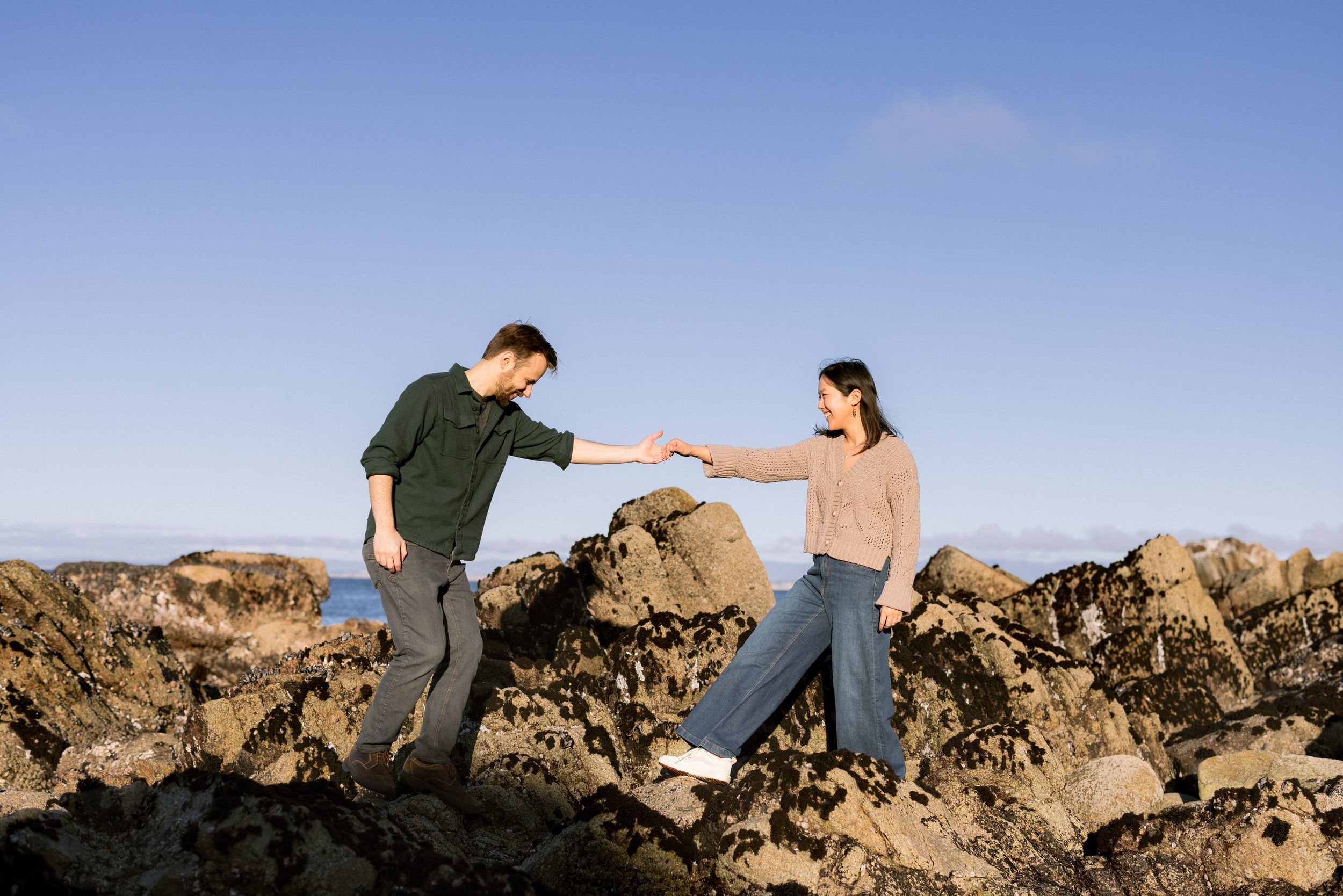 Monterey engagement portraits along rocky coastline
