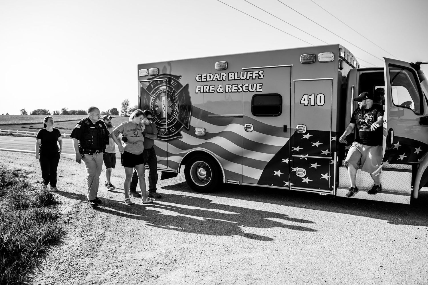 Group of people gathered outside emergency response during a home birth transfer