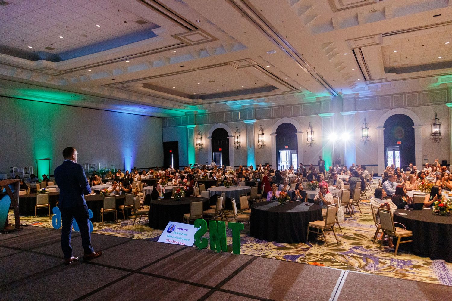 Conference speaker on stage and the audienceat the Spring Educators Conference held at the Wyndham Grand Rio Mar in Rio Grande, Puerto Rico.