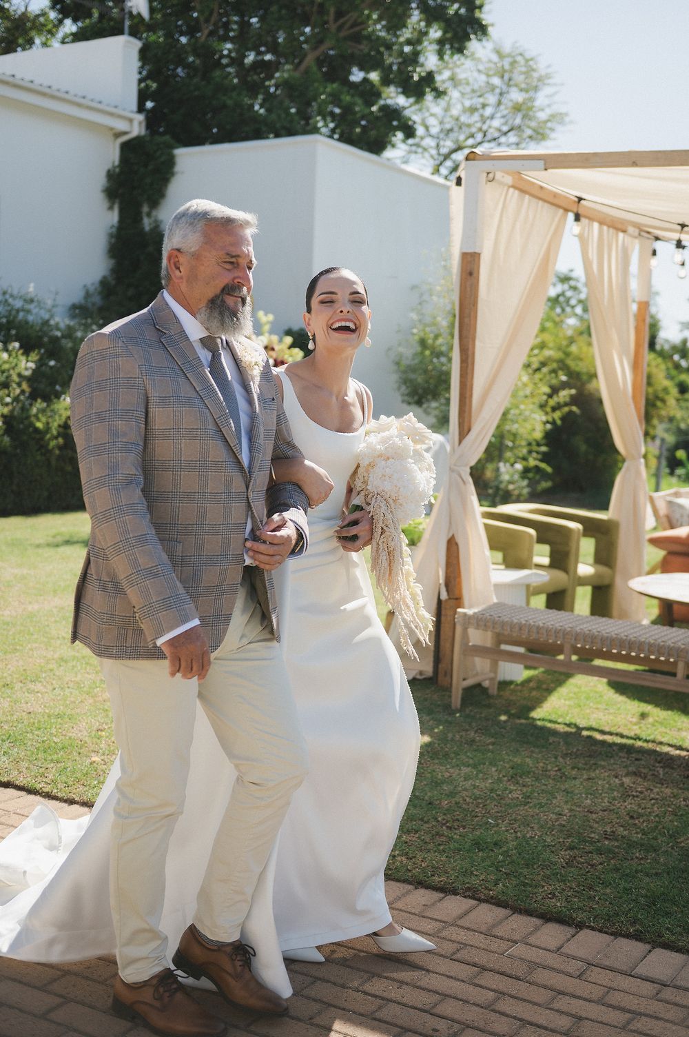 Bride walking down the aisle with family member
