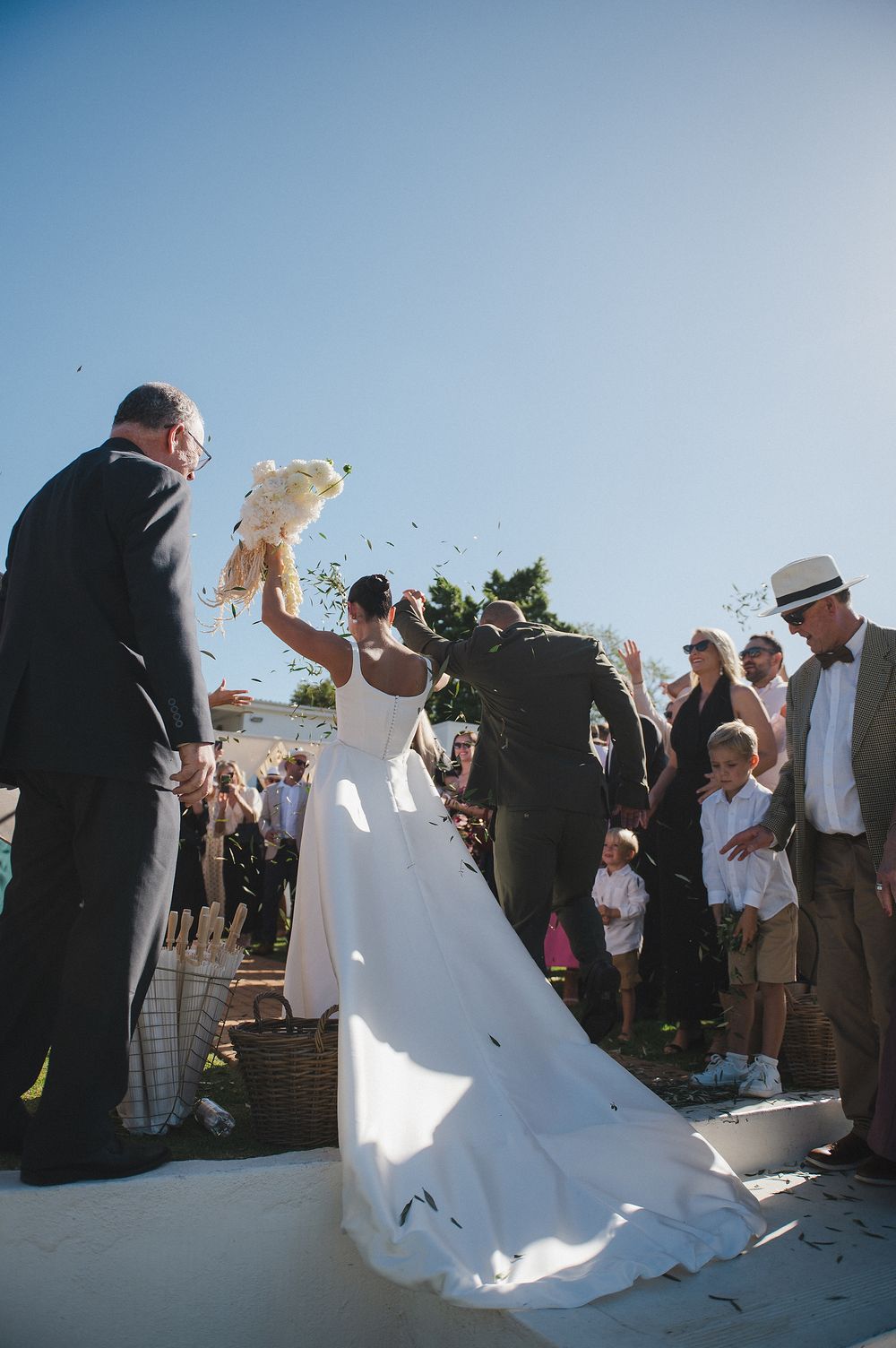 Romantic wedding aisle and bride lifting bouquet