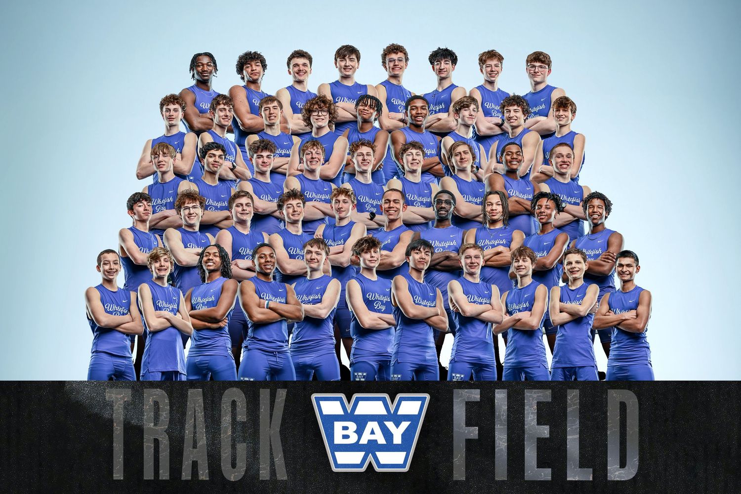 Bay Track and Field team photo with athletes in blue uniforms posing together for a group portrait.