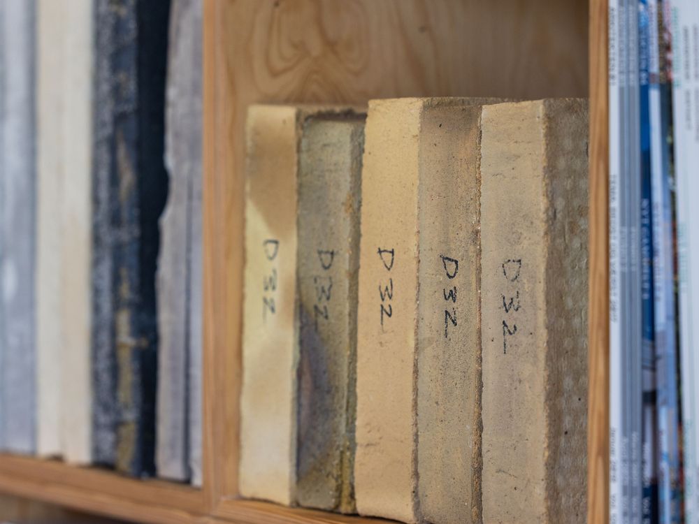 Vintage books labeled D32 arranged on a wooden shelf, showing aged spines with handwritten labels.